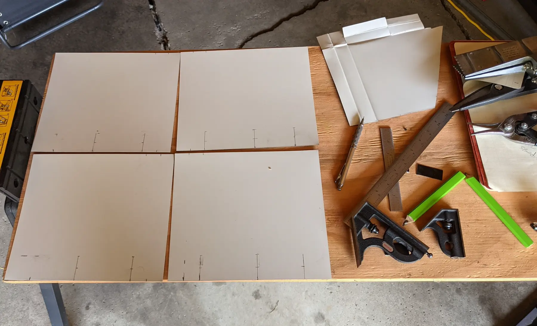 Flat aluminum-coil blanks marked with bend lines.