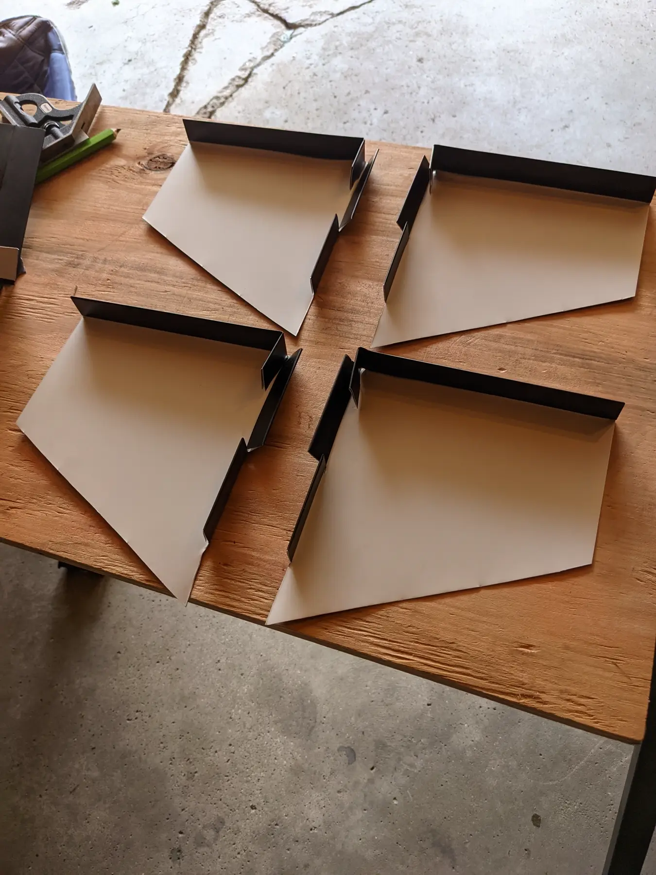 Back sides of folded flashing samples showing hems and returns.