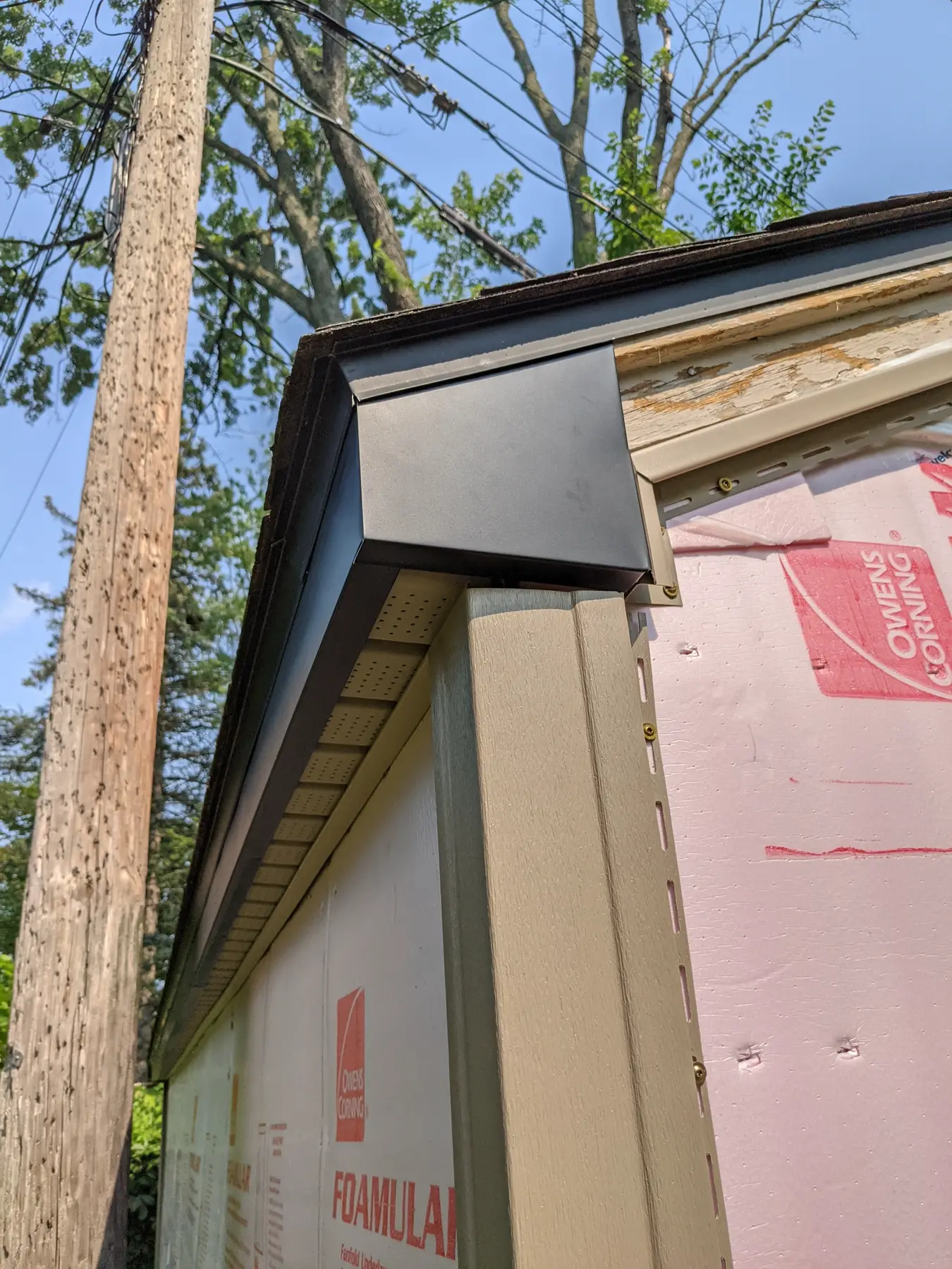 Custom flashing installed at an eave and corner.