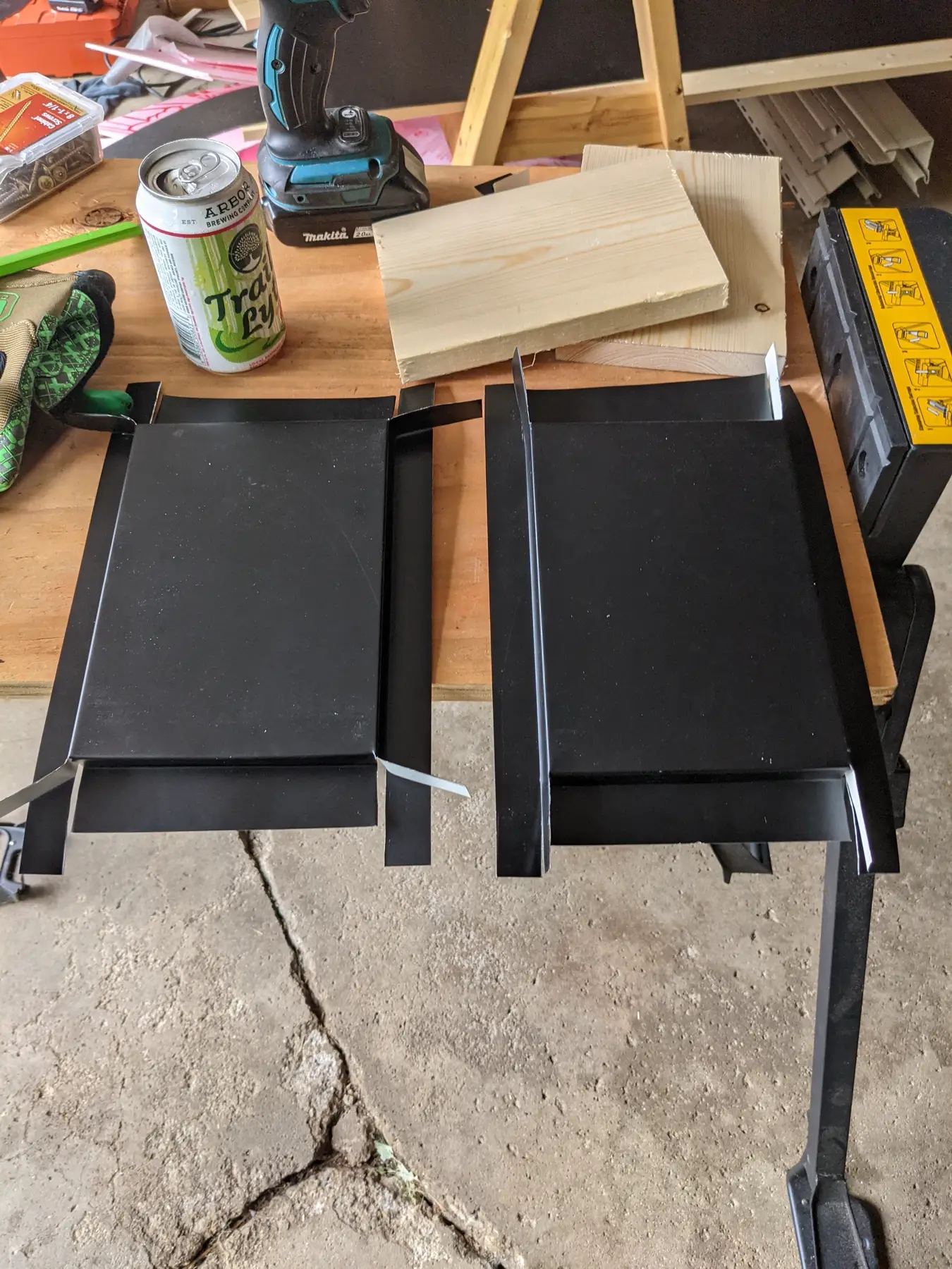 Several completed custom flashing profiles arranged on a workbench.