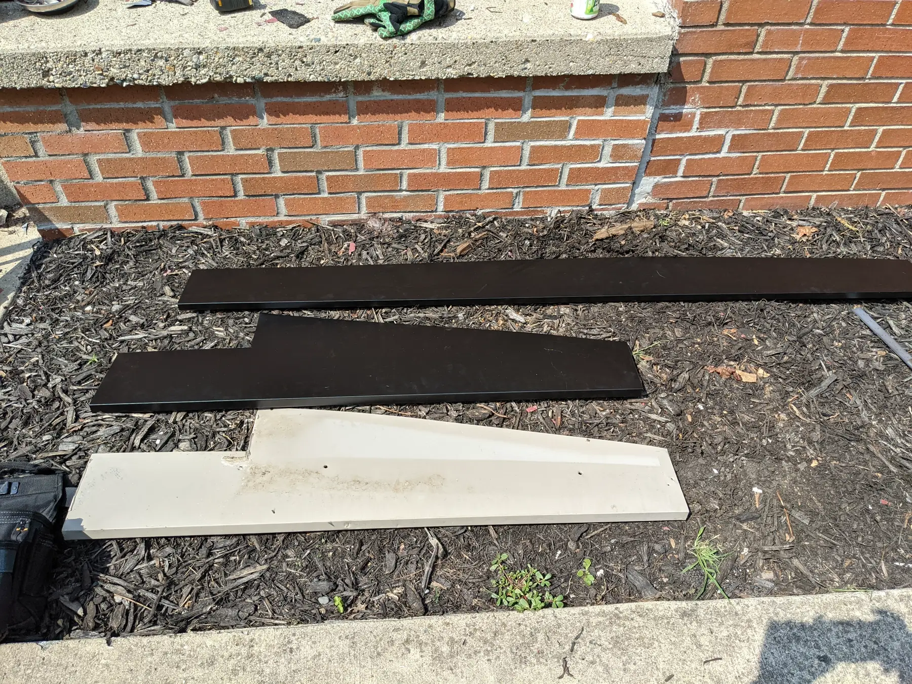 Long finished trim pieces staged after coating.