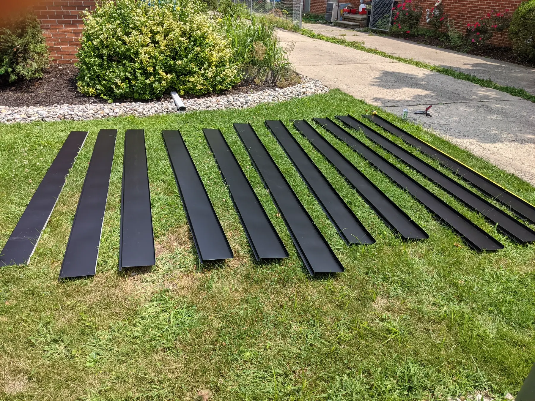 Many long flashing strips laid out together on grass.