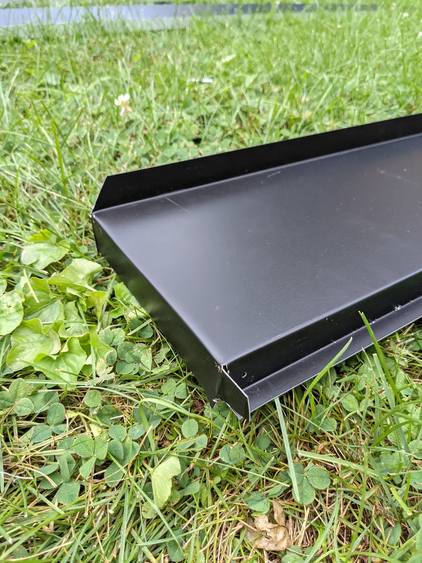 Tray-shaped corner flashing profile after fabrication.