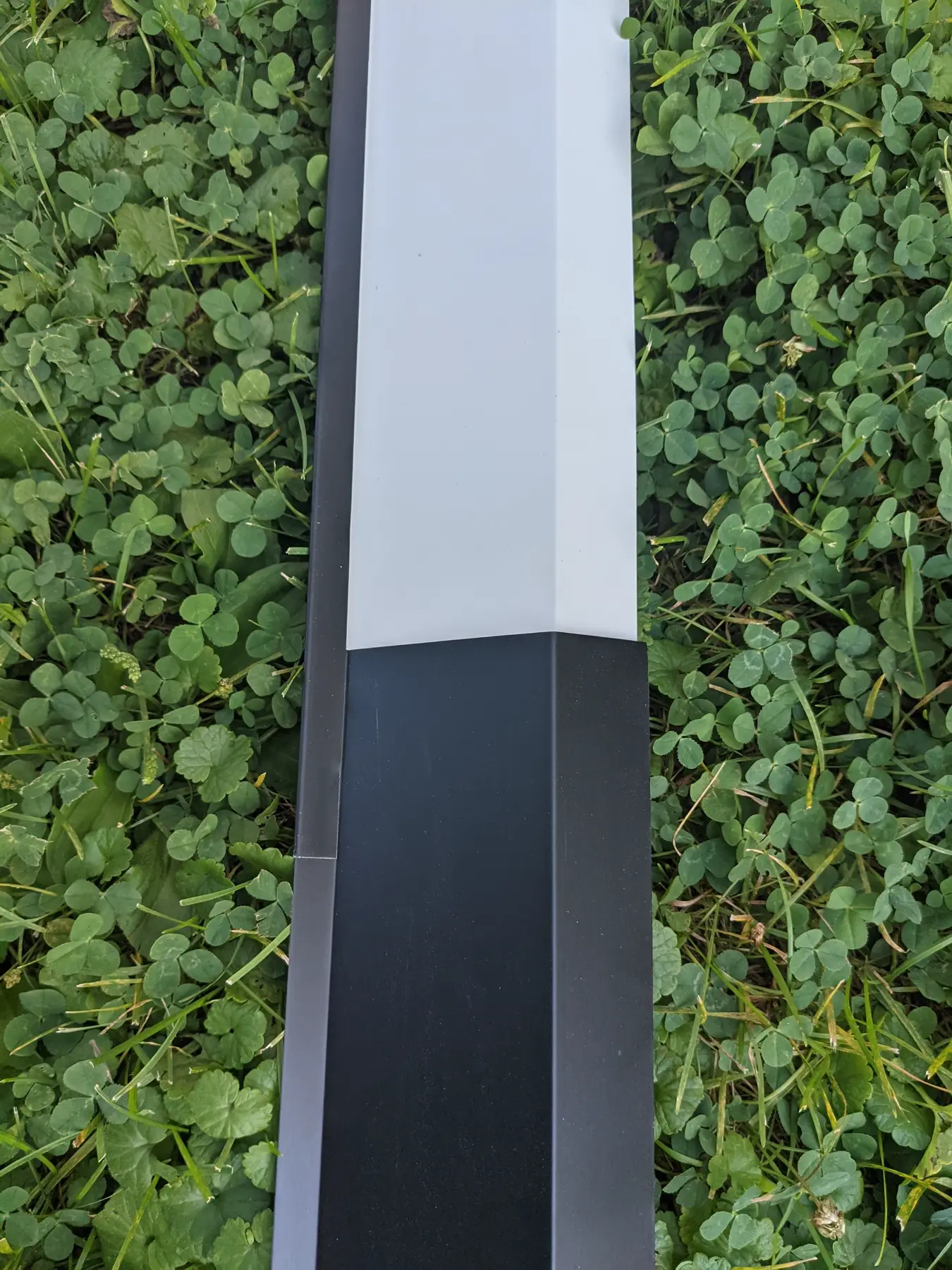 Transition between light siding trim and dark custom flashing.