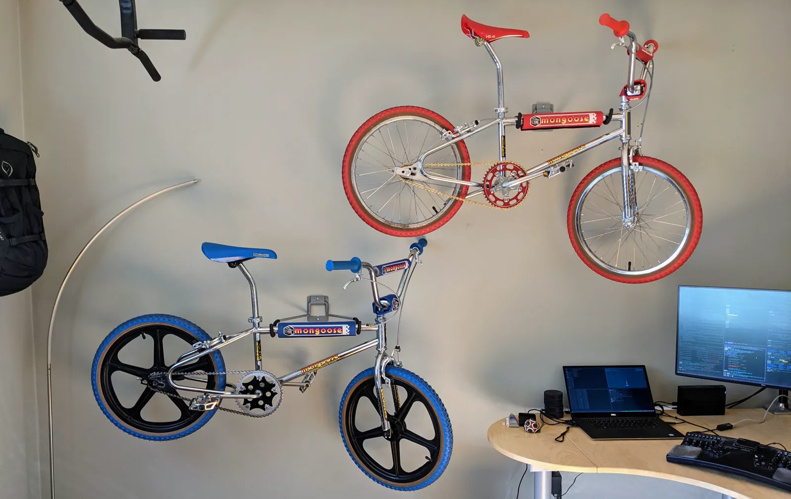The restored red and blue Mongoose Californians displayed together indoors.