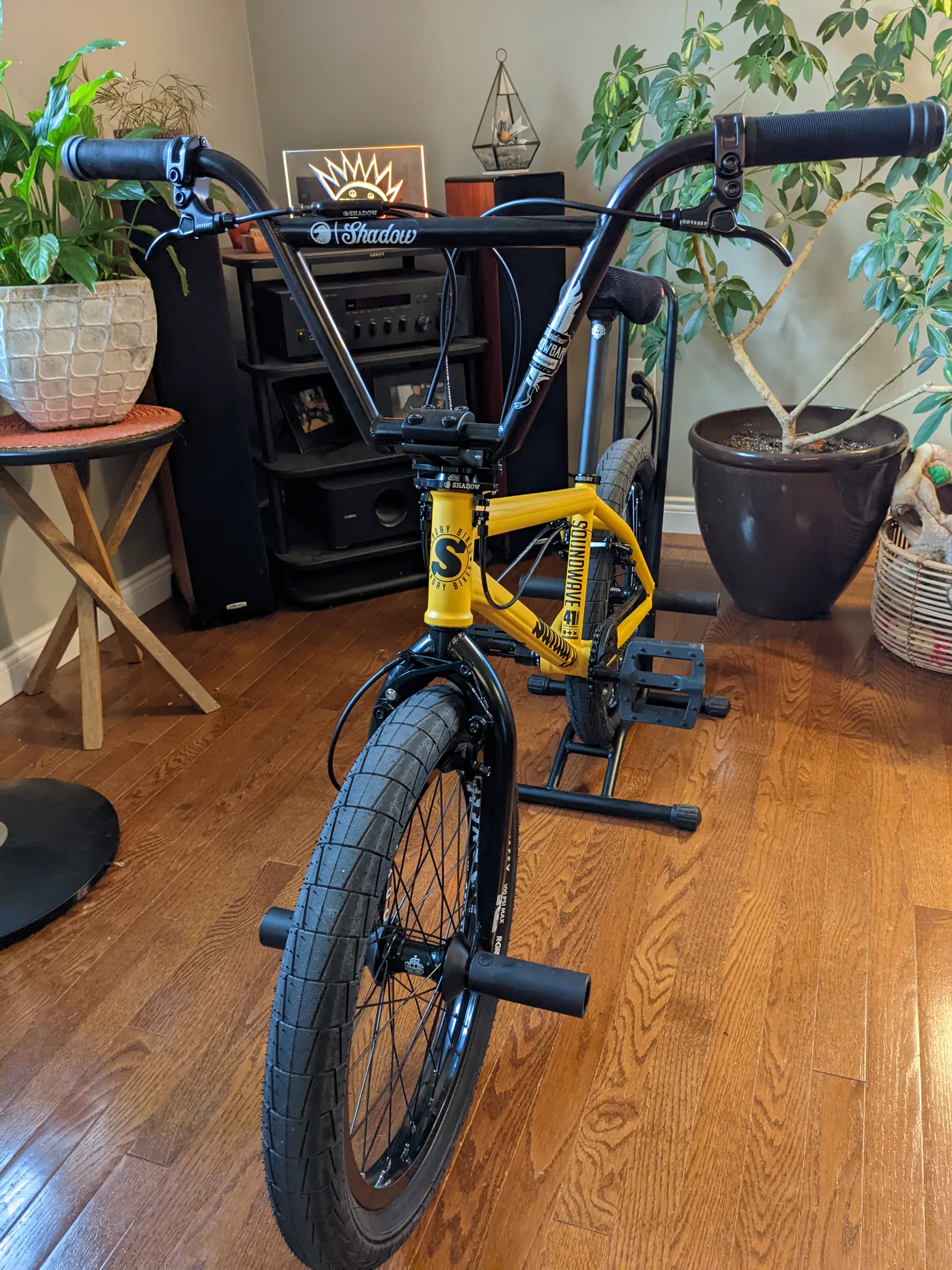 Indoor front three-quarter view of the yellow Sunday Soundwave on a stand.