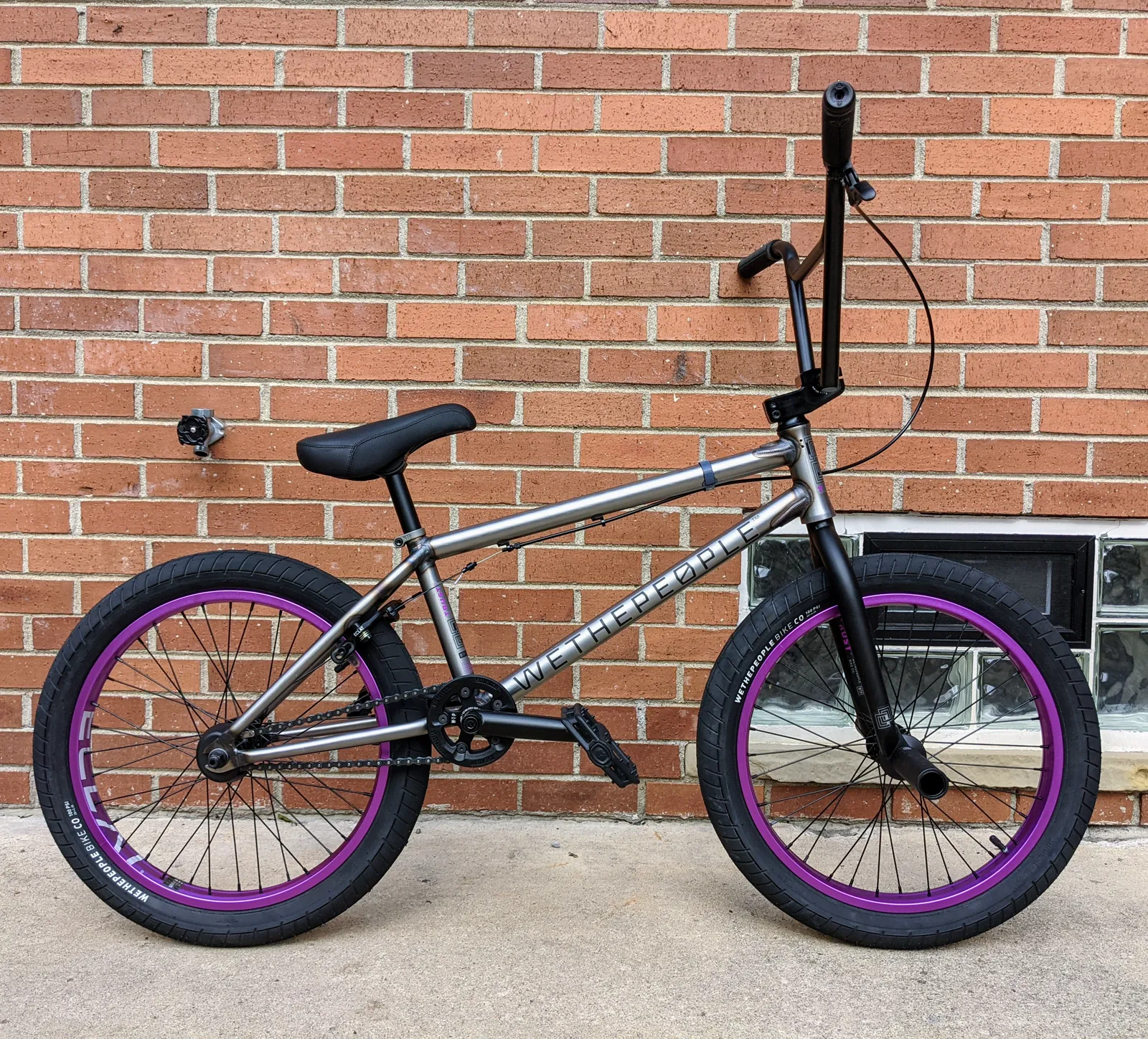 First outdoor side profile of the raw WTP Trust FC with purple rims.