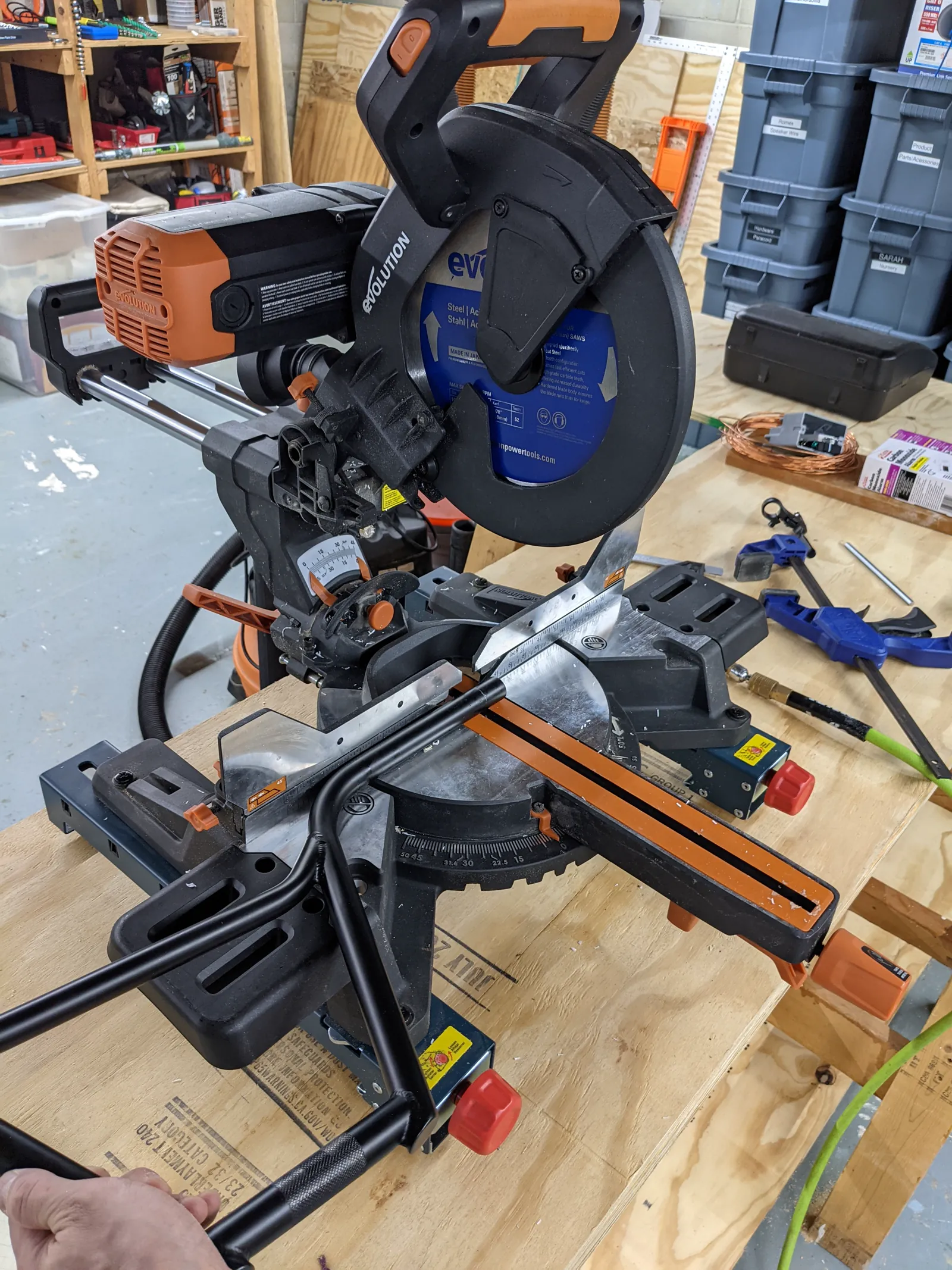 Black BMX handlebars positioned at a miter saw to shorten their overall width.