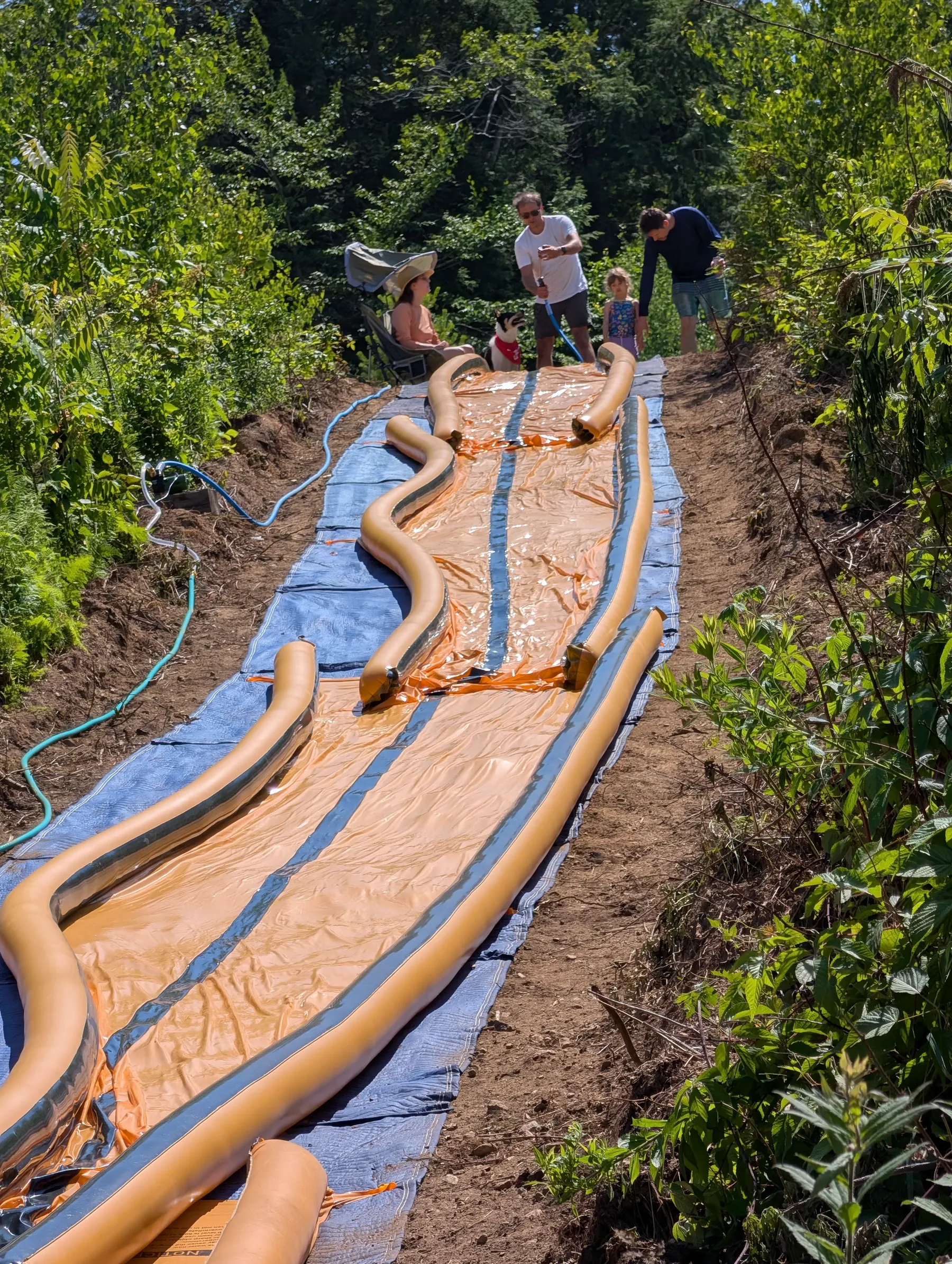 The top operator testing the water wand over the installed orange slide sections.