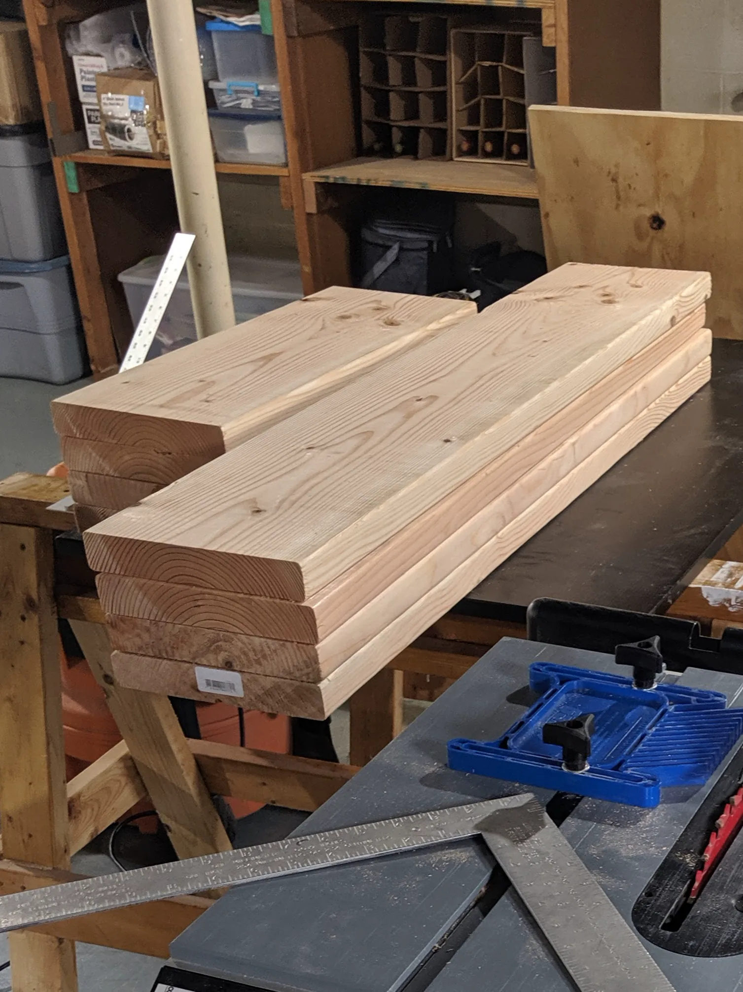 Rough fir boards stacked on a workshop bench before milling.