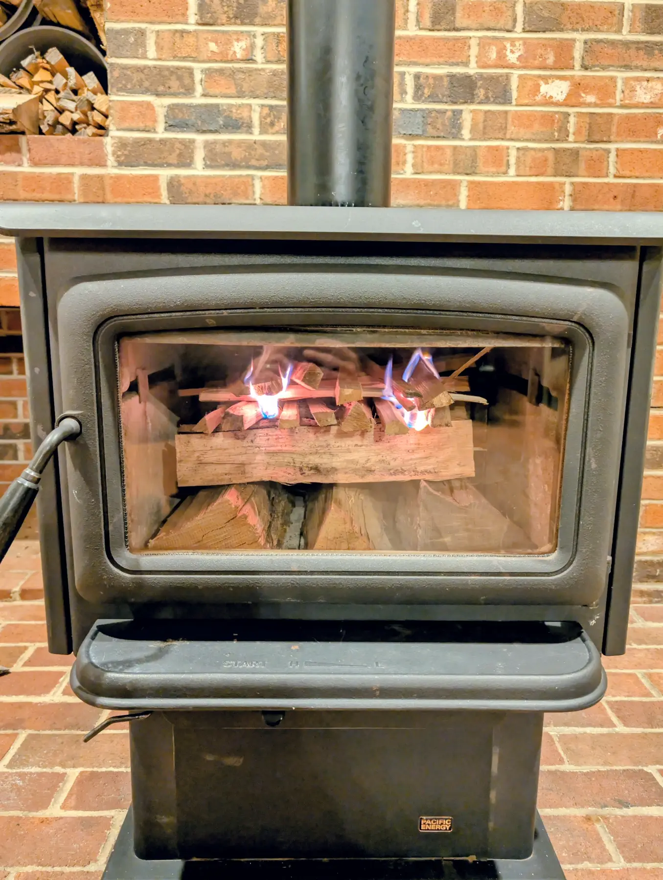 Close front view of the first fire burning inside the Pacific Energy woodstove.